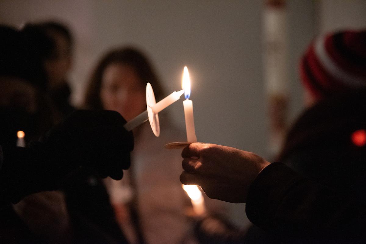 A photo of two candles lighting eachother